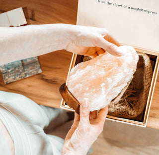 Inside view of the Slat Lamp gift Box by Saltanat. The recipient is holding the beautiful Salt Lamp in their hands.